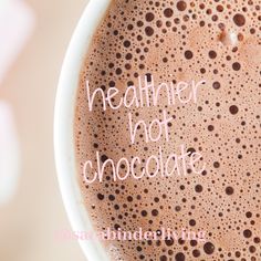 a close up of a cup of coffee with the words healthier not chocolate on it