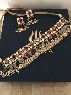 One of our favorite picks for the wedding season 2022♥️ The gorgeous choker is beautifully handcrafted by our skilled Indian craftsmen in Kundan, stones, beads, mini pearls, and gold plated. The beautiful Kundan earrings add to the traditional ethnicity of the piece. Material: Brass, silver, copper with gold plating  Length of earrings: 5 cms  Width of earrings: 2.5 cms Heavy Multicolor Wedding Sets, Heavy Multicolor Bridal Sets For Wedding, Multicolor Kundan Necklace For Wedding, Heavy Multicolor Bridal Necklace For Reception, Multicolor Bridal Necklace With Intricate Design For Wedding, Heavy Multicolor Bridal Necklace For Wedding, Bollywood Style Multicolor Bridal Necklace, Multicolor Bridal Sets With Tilla For Wedding, Multicolor Festive Bridal Sets For Wedding