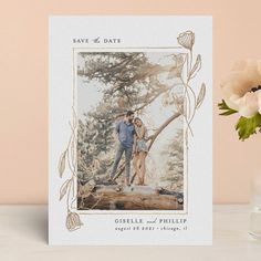 a card with an image of a man and woman standing on a log