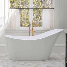 a white bath tub sitting next to a window