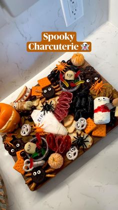 an assortment of halloween treats on a tray with the words spooky character x