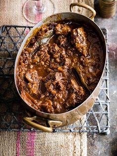 a large pot filled with stew on top of a table