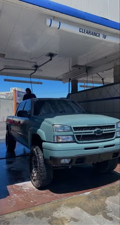 the truck is parked at the gas station