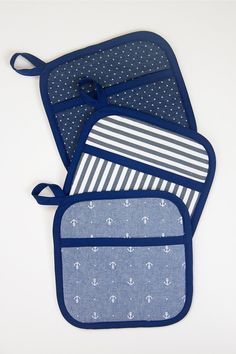 three oven mitts with anchors and stripes on them