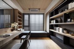 an office with wooden shelves and black furniture