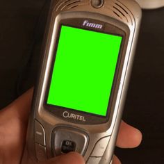 a person holding a cell phone with a green screen