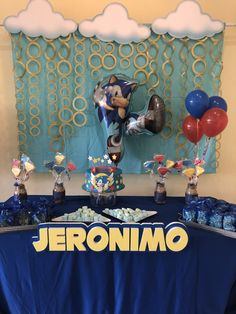 an image of a sonic birthday party with balloons and desserts on the table in front of it