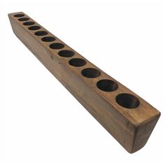 a wooden block with six holes on it