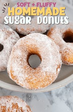 homemade sugar donuts on a plate with powdered sugar