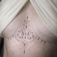 a woman's stomach with an intricate design on it