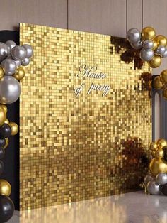 a gold and silver party decoration with balloons