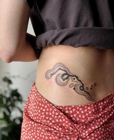 a woman with a tattoo on her stomach