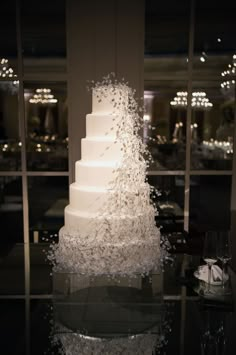 a white wedding cake sitting on top of a table