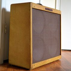 an old amp sitting on the floor in front of a door