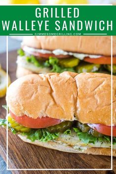 grilled walleye sandwich with lettuce, tomato and pickles on a cutting board