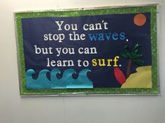 a bulletin board with an ocean theme on the front and back wall, which reads you can't stop the waves but you can learn to surf