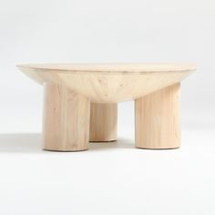 a wooden table sitting on top of a white floor