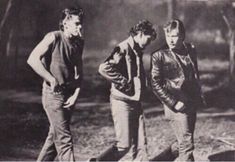 three young men standing next to each other