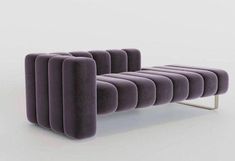 a purple couch sitting on top of a white floor