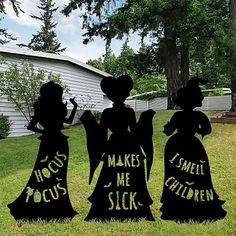 three black silhouettes with words on them in front of a house and yard area