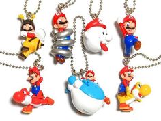 four different key chains with mario and other cartoon characters hanging from it's sides