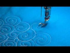 the video shows how to sew on an appliqued piece of fabric