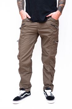 Shri Yantra Khaki NY Pants Men's Stretchable Screen Printed Pants: These men's cargo trousers combine comfort, style, and functionality, making them a versatile addition to your wardrobe for all your daily adventures. 1. Material: Made with 100% stretchable high-quality cotton fabric for ultimate comfort and flexibility. The cotton fabric is gentle on the skin, ensuring comfort even during extended wear. 2. Multiple Pockets:    - Two regular pockets for convenient storage of everyday items.    - Four regular zipper pockets for added security and organization.    - Two small zipper pockets for smaller essentials.    - One secret pocket for discreet storage of valuable items. 3. Comfortable Fit: These cargo trousers are incredibly comfortable due to their flexibility and stretchable nature, Fitted Brown Bottoms For Outdoor, Fitted Pants With Zip Fly For Outdoor, Mens Cargo Trousers, Cargo Pants For Men, Shri Yantra, Cotton Cargo Pants, Mens Cargo, Pants For Men, Cargo Pant