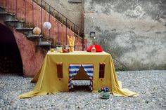 a table with a tent on it next to some stairs