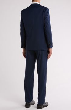 Bring understated elegance to the table in this three-piece suit crafted from rich fabric in a classic single-breasted silhouette. Jacket has notched lapels; chest welt pocket; front flap pockets Vest has front button closure; V-neck Pants have zip fly with button closure; front slant pockets; back button-welt pockets Jacket and vest are lined; trousers are lined to the knee 65% polyester, 35% viscose Dry clean Imported Suit has a 6” drop, meaning that a size 38R jacket is paired with size 32 pa Elegant Business Casual Set With Double Button Closure, Elegant Sets With Double Button Closure For Business Casual, Fitted Single Breasted Three-piece Suit With Notch Lapel, Slim Fit Single Breasted Set With Notch Lapel, Slim Fit Three-piece Suit With Welt Pockets, Semi-formal Slim Fit Three-piece Suit With Welt Pockets, Slim Fit Three-piece Suit With Notch Lapel, Semi-formal Suiting Fabric Sets With Notch Lapel, Tuxedo Style Pantsuit With Notch Lapel And Hidden Buttons