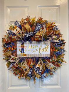 a happy fall wreath is hanging on the front door with an orange, yellow and blue ribbon