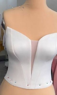 a mannequin wearing a white corset