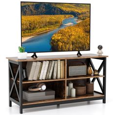 a flat screen tv sitting on top of a wooden stand next to a book shelf