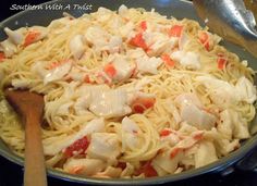 a pan filled with pasta and chicken on top of a stove