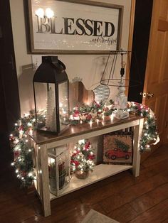 a table with christmas decorations and lights on it in front of a sign that says blessing