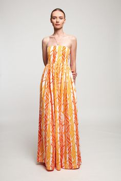 DESCRIPTION This floaty dress is made from lightweight cotton printed with a Spanish-inspired arrangement of golden yellow and orange hues. Cut for a close fit, it has a flattering halterneck and softly pleated skirt for ease of movement. Temper the maxi hem with sandals or heels. * Prints and colours may vary slightly Orange Halter Neck Dress For Summer, Chic Orange Halter Dress For Summer, Orange Summer Halter Neck Dress, Orange Halter Neck Maxi Dress For Spring, Orange Maxi Length Halter Dress For Summer, Orange Maxi Length Halter Dress For Beach, Yellow Strapless Maxi Dress For Spring, Strapless Yellow Maxi Dress For Spring, Orange Strapless Sundress