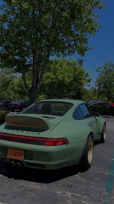 a green sports car parked in a parking lot