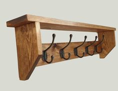 a wooden coat rack with hooks on it