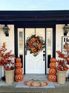 two pumpkins are sitting on the front porch