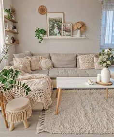 a living room filled with furniture and plants