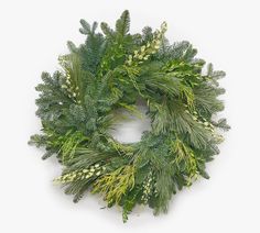 a green wreath with white flowers and greenery