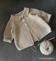 a knitted sweater and crochet pattern next to a ball of knitting yarn