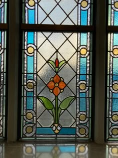 three stained glass windows with flowers on them