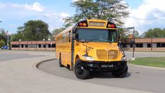 a yellow school bus driving down the street