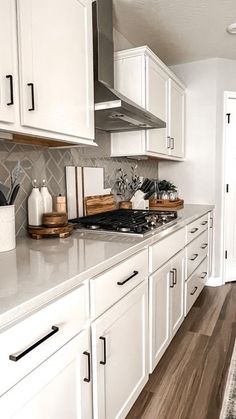 the kitchen is clean and ready for us to use it's white cabinetry