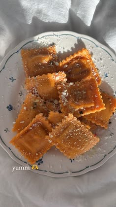 some food is sitting on a plate with water droplets and powdered sugar around it