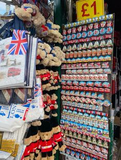 there are many teddy bears on display in the store and one has a british flag