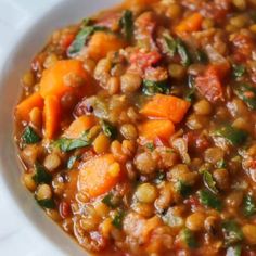 a white bowl filled with lentils and carrots