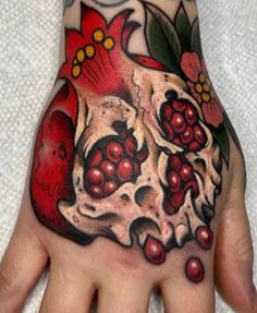 a hand with a skull and flowers on it