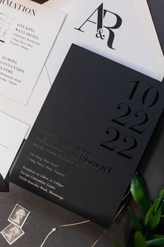 an elegant black and white wedding suite with monogrammed details on the front cover