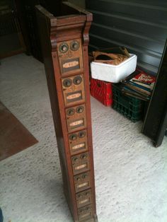 an old wooden grandfather clock sitting on top of a white carpeted floor next to boxes